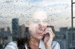 woman looking out windows
