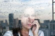 woman looking out windows